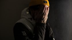 man covering his face with both hands