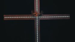 a wooden cross with a crown on top of it