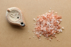 a pile of sea salt next to a small piece of stone